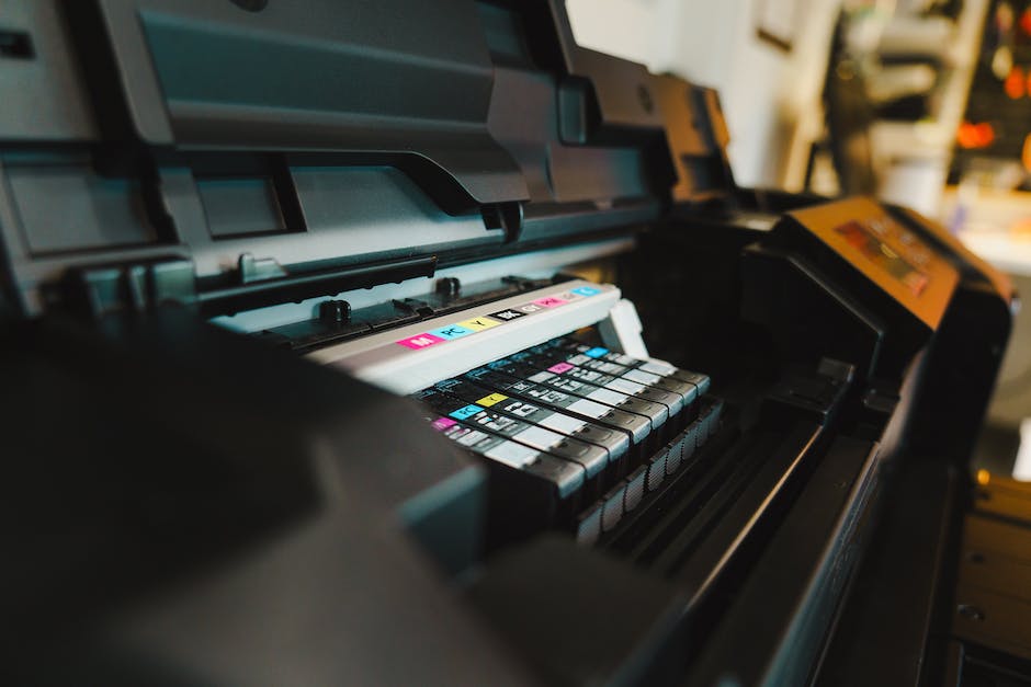 Image depicting a person checking ink levels on a printer